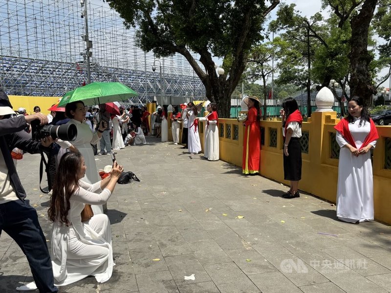 去年9月越南國慶前夕，河內景點周邊人潮洶湧，人們一樣為了跟上社群媒體熱潮，一窩蜂穿上奧黛、披上國旗搶拍照片。專業攝影師也樂於賺一批快錢。中央社記者曾婷瑄河內攝　115年1月14日