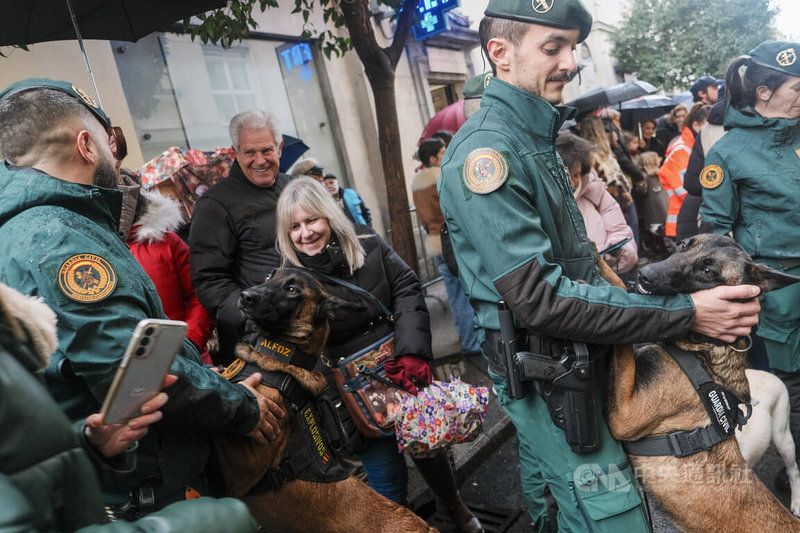 西班牙首都馬德里聖安東教堂1月17日為慶祝「聖安東節」舉行的「動物大遊行」中，馬德里警察局、民防局、消防局與國民警衛隊的警犬和搜救犬都來共襄盛舉，警犬們不斷趴到領犬員身上要求抱抱的萌樣，引發民眾愛憐。中央社記者胡家綺馬德里攝 115年1月18日