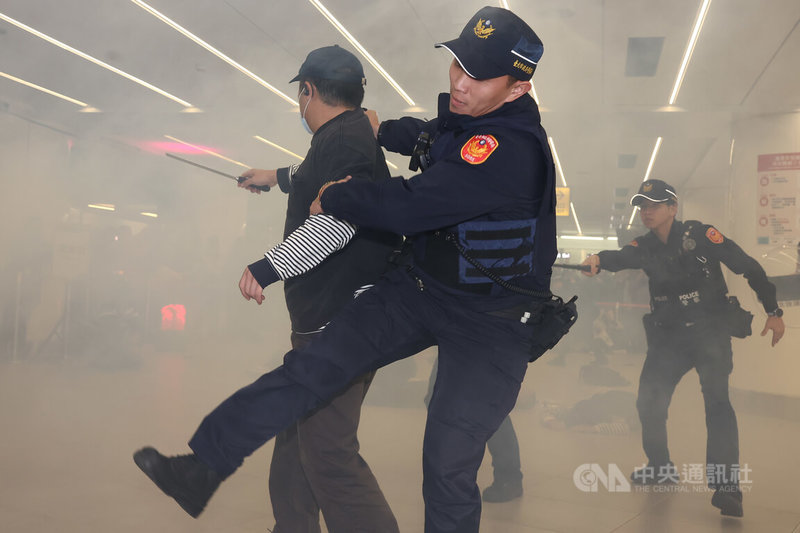 台北車站特定區「無差別攻擊危安實兵演習」22日登場，模擬歹徒逃竄至三鐵共構區丟擲煙霧彈並攻擊民眾，警察趕到圍捕，最終成功將歹徒壓制。中央社記者王騰毅攝　115年1月22日