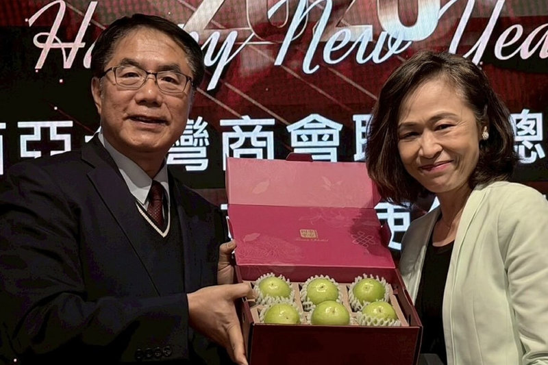 台南市長黃偉哲（左）前往馬來西亞行銷農產品，24日晚間參與當地台商聚會，贈送台南蜜棗給駐馬來西亞台北經濟文化辦事處代表連玉蘋（右）。（市府提供）中央社記者楊思瑞台南傳真　115年1月25日