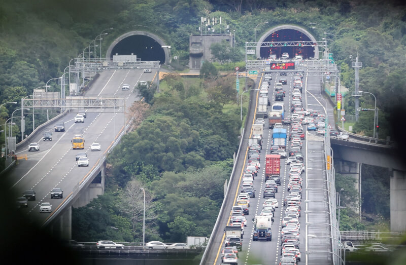 228連假首日，根據即時路況顯示，截至27日中午12時35分，國1北向汐止系統-汐止、國3南向環東-南港與北向安坑-新店等路段呈現車速20公里以下紫色。圖為木柵往南港段車流量多，車速緩慢。中央社記者郭日曉攝　115年2月27日