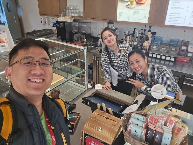 28日美伊開火，阿聯第一大商業城杜拜多處受到戰火波及。常駐杜拜台商吳天麟（左）1日與熟悉的商家店員互相交換親身體驗「戰爭」的難忘心得。（吳天麟提供）中央社記者施婉清開羅傳真 115年3月2日