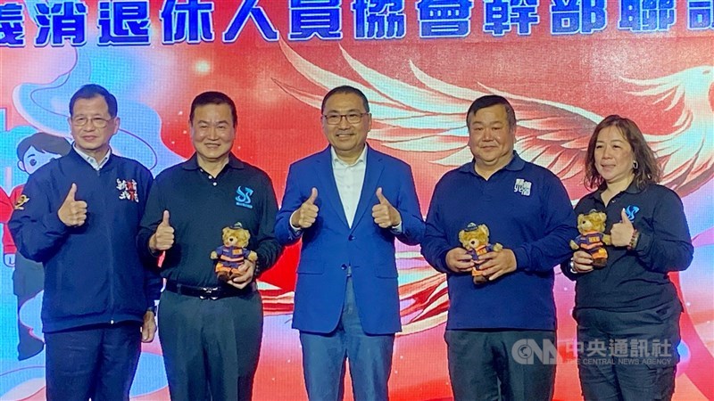 新北市政府13日舉辦消防及義消人員「回娘家」暨全國退休消防協會幹部聯誼會，市長侯友宜（中）頒發「消防家庭貢獻獎」給雙和救護義消中隊羅文崇（左2）一家。 中央社記者黃旭昇攝　115年3月13日