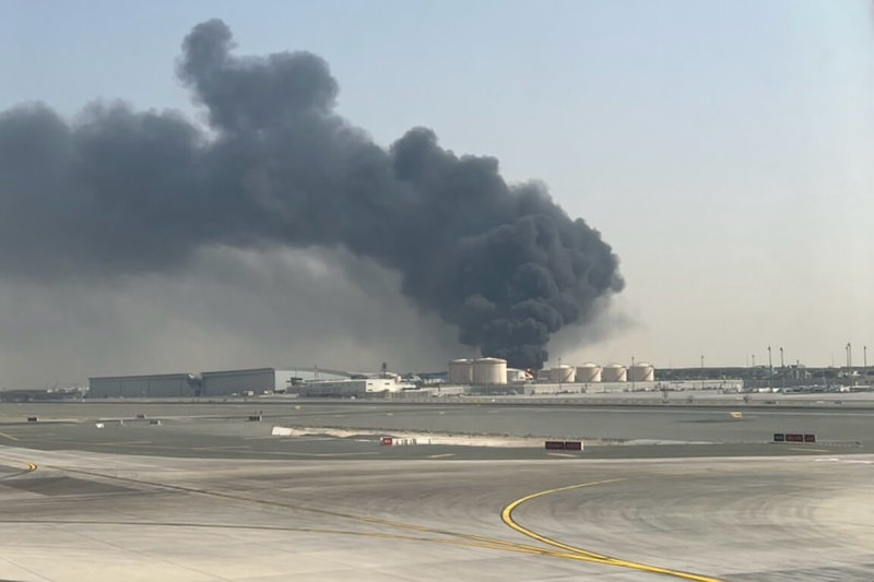 杜拜國際機場因附近發生無人機相關事件引起火災一度暫停起降，受事故影響延誤返台的民眾17日表示，目睹天空亮著紅光、燃料槽冒濃煙，直到班機起飛時仍持續冒煙。（民眾提供）中央社記者吳睿騏桃園機場傳真　115年3月17日