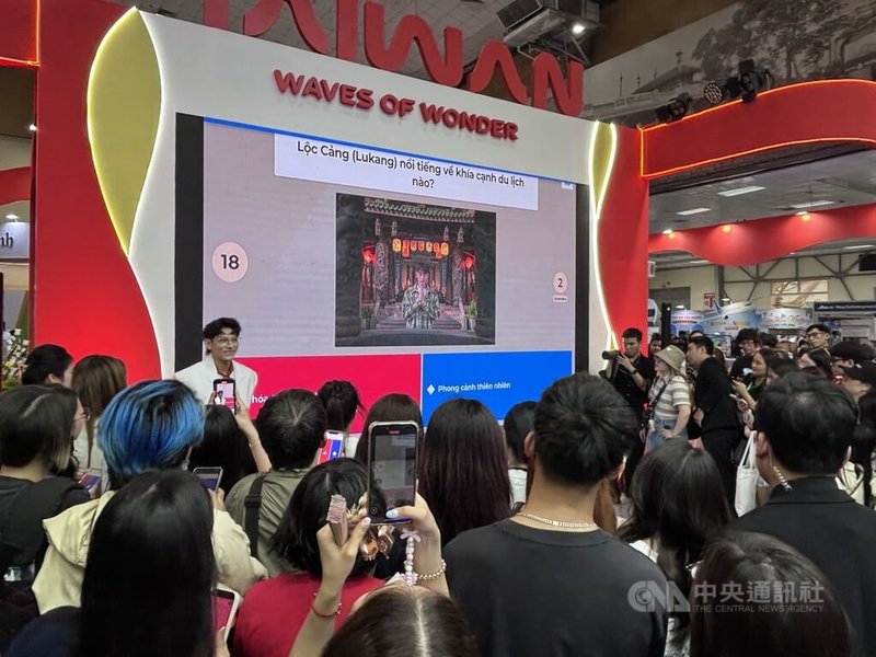 自2025年起擔任越南市場台灣觀光代言人的越南人氣偶像ISAAC(台上)11日在河內國際旅展台灣館現場演出,並與歌迷進行台灣旅遊相關的互動遊戲,熱情粉絲把台灣館包圍。中央社記者曾婷瑄河內攝 115年4月12日