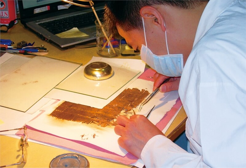 莎草紙學家張瑞林為古埃及莎草紙進行殘卷修復工作。（中央社施婉清）
