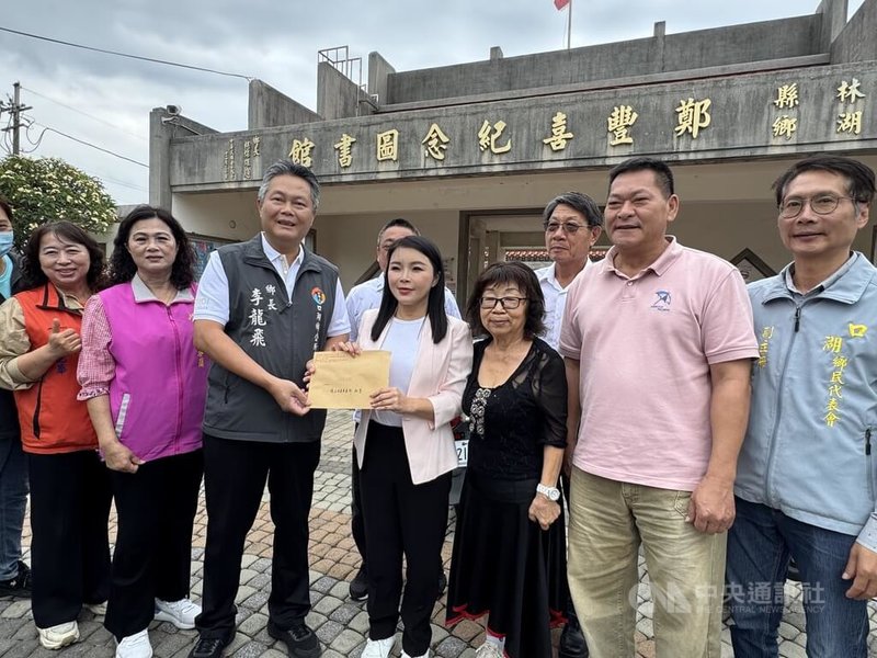 國民黨雲林縣長參選人張嘉郡（前右4）30日向鄭豐喜遺孀吳繼釗（前右3），提「偏鄉閱讀翻轉計畫」，允諾若中央資源不到位，她當選縣長後主動承擔口湖鄉立鄭豐喜紀念圖書館重建經費，並導入科技與AI學習機制。　中央社記者姜宜菁攝　115年4月30日