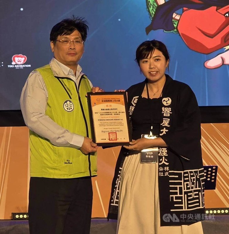 2026澎湖國際海上花火節4日晚間在馬公觀音亭園區引爆，開幕秀由日本煙火團隊搭配動漫「七龍珠Z」主題施放逾萬發煙火，副縣長林皆興（左）致贈感謝狀給日本煙火團隊。中央社　115年5月4日