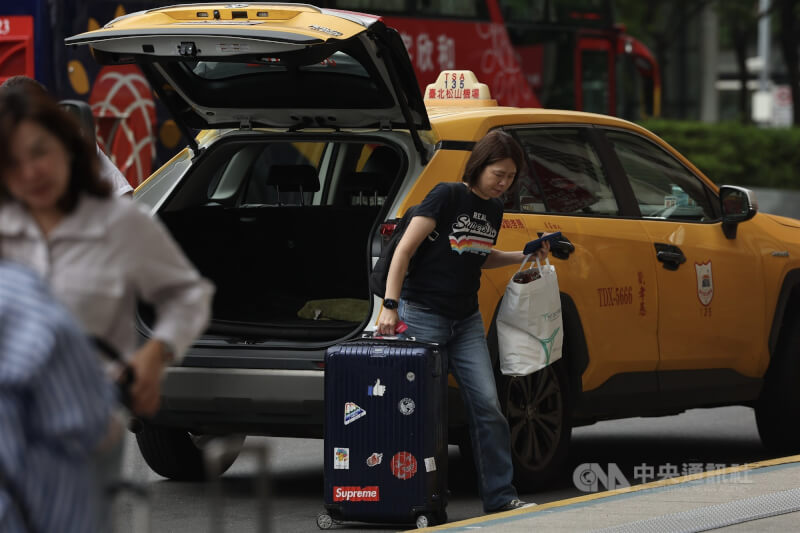 圖為台北車站旁搭乘計程車的乘客。（中央社檔案照片）