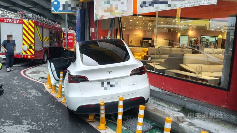 新北市三重區新北大道2段14日傍晚有民眾駕駛一輛特斯拉電動車，疑因精神不濟，意外撞上傢俱行，車頭嚴重毀損，幸未殃及旁人，僅駕駛輕傷送醫。（翻攝畫面）中央社記者曹亞沿傳真　115年5月14日
