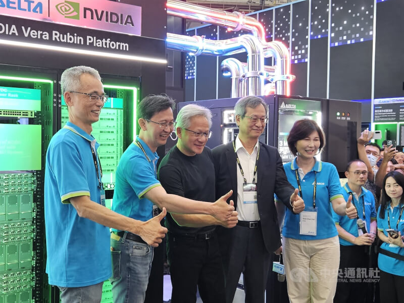 輝達(NVIDIA)執行長黃仁勳(前排中)3日逛COMPUTEX展場,前往合作夥伴台達電攤位站台,台達電總裁張訓海(前排右2)、品牌長郭珊珊(前排右1)、電源及系統事業群總經理陳盈源(前排左2)、電源及零組件事業範疇執行副總裁史文景(前排左1)等主管親自接待。中央社記者曾仁凱攝 115年6月3日