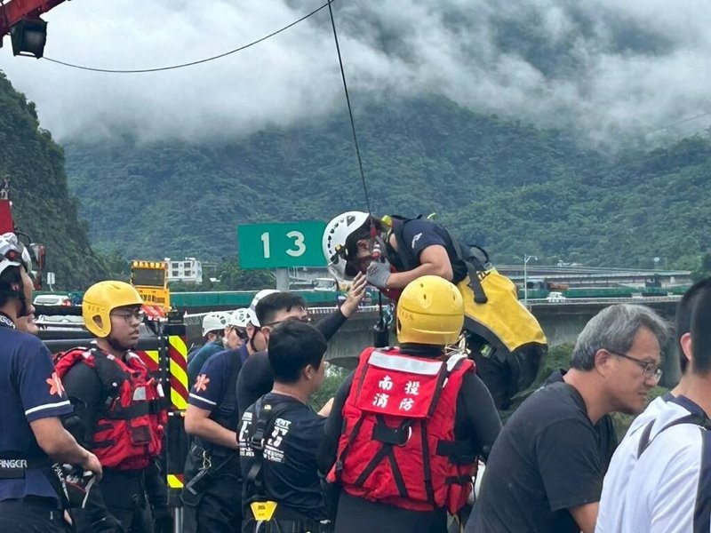 3名工人10日在國道6號下方溪床巡視工地、加固設施時，因降雨導致溪水暴漲而受困，南投縣政府消防局派遣人車從國道垂降到溪床救出3名受困者。（交通部高速公路局提供）中央社記者蕭博陽南投縣傳真　115年6月10日