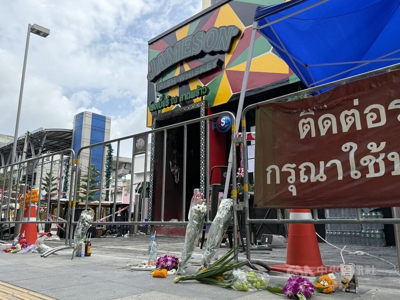 泰國曼谷啤酒餐廳發生重大火災後,門外圍起封鎖線,有民眾在地上擺放鮮花悼念罹難者。警方持續調查起火原因,並釐清場所登記類別是否與實際經營型態相符。中央社記者李宗憲曼谷攝 115年7月14日