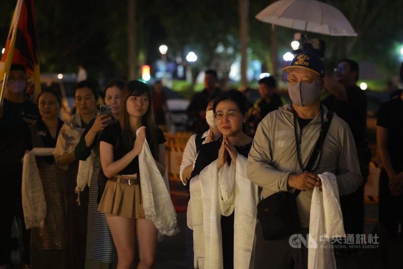 多個人權團體發起舉辦的「追悼洛嘎讓贊供身自焚 抗議中共民族團結促進法」活動15日晚間在台北自由廣場舉行,盼藉集會追悼自焚抗議的流亡藏人洛嘎讓贊。圖為與會民眾依序向洛嘎讓贊遺像獻上哈達。(請珍惜生命。自殺防治專線(24小時):0800-788-995;生命線:1995。)中央社記者王飛華攝 115年7月15日