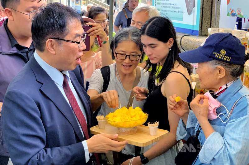 台南市長黃偉哲(前左)18日到桃園出席「台南夏日芒果祭」時表示,桃園市消費力驚人,這次特地帶來芒果、百香果、木瓜、香蕉及多項農特產加工品,要向桃園民眾推廣台南優質農產。中央社記者吳睿騏攝 115年7月18日