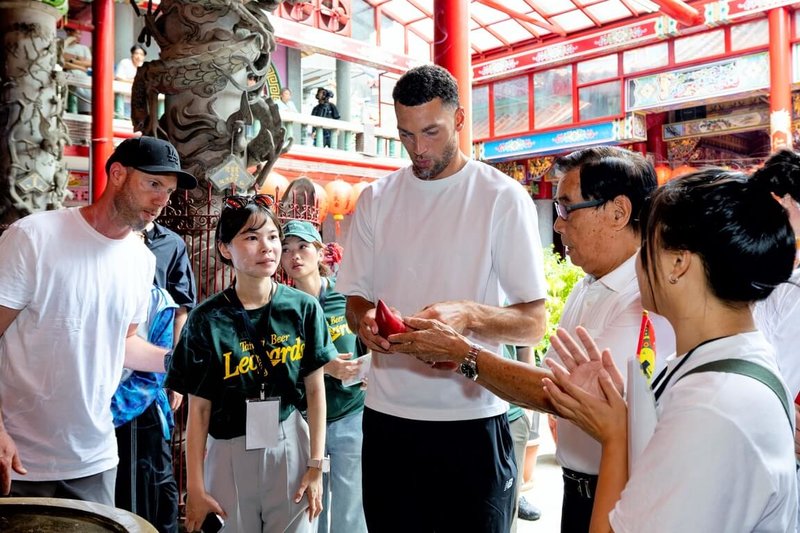 美國職籃NBA球星拉文（Zach LaVine）（右3）來台參加「2026桃園珍珠海岸國際音樂節」，2日下午走訪大溪老街，前往福仁宮參拜祈福，並體驗擲筊儀式。（桃園市政府觀光旅遊局提供）中央社記者吳睿騏桃園傳真　115年8月2日