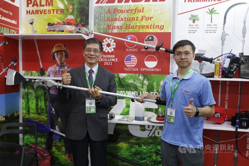 台灣農業機械工業同業公會理事長姚倍欽（左）在馬來西亞農業科技展展示台灣業者研發的油棕採收機具，盼透過省工、省力設備，因應當地農業缺工與技術升級，搶攻智慧農業需求。中央社記者黃自強吉隆坡攝　115年9月14日