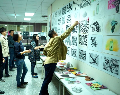 商設系徐宏文等位老師進行評審時(右一),為優秀作品貼上紅標。
