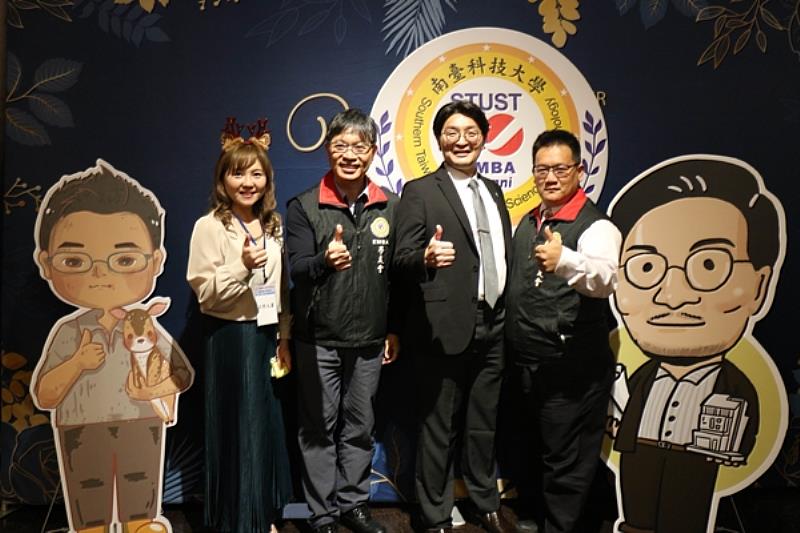 南臺科大EMBA學友會缷任理事長林昆鋒(右一)與新任理事長黃志煌(右二)、EMBA鄭滄祥執長、EMBA校友及二側新缷任理事長Q版人像立牌合影。