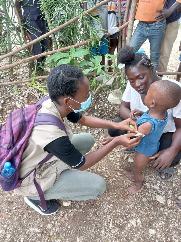 測量孩童的上臂圍，來初步判斷他們的營養狀況。(照片提供：對抗飢餓組織海地分會(Action Against Hunger Haiti))