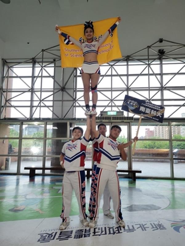 3.南臺科大競技啦啦隊一般男女混合4人組賽後與校旗合影。