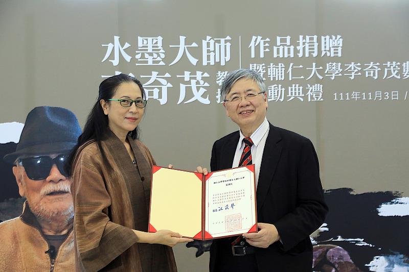 李奇茂之女李安榮（左）代表贈畫給輔大，江漢聲校長代表受贈（右）
