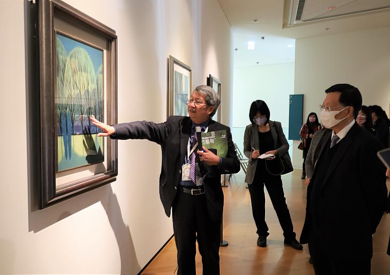 圖為亞大校長蔡進發(右1)在展場，聽亞美館館長潘襎(左1)導覽介紹蕭如松的作品。