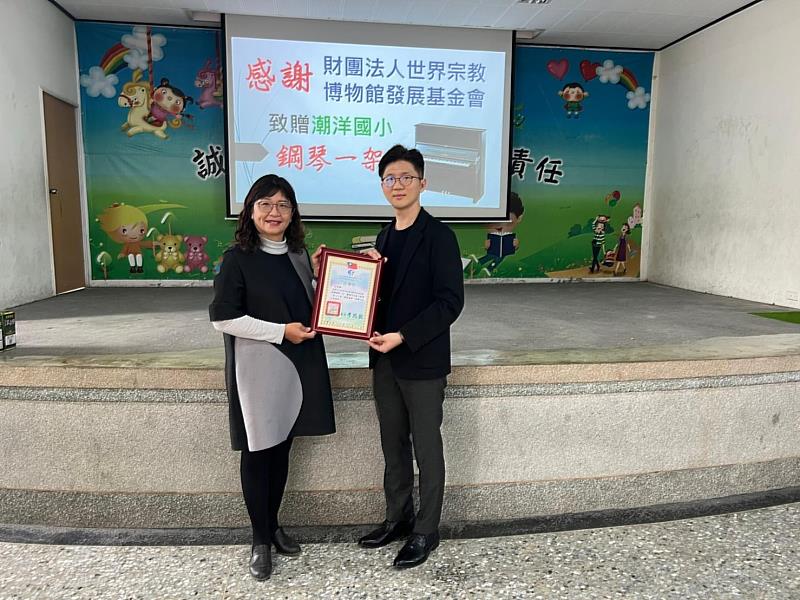 彰化縣溪州鄉潮洋國小校長李瑞緻（左）致贈感謝狀給世界宗教博物館發展基金會執行長室主任林炳邑。（圖由潮洋國小提供）