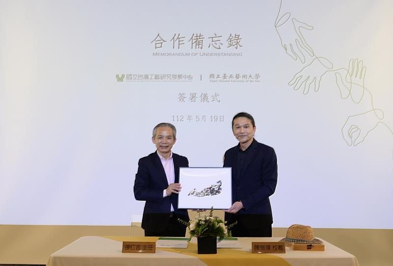 國立臺北藝術大學校長陳愷璜(左)致贈版畫予國立臺灣工藝研究發展中心為紀念。