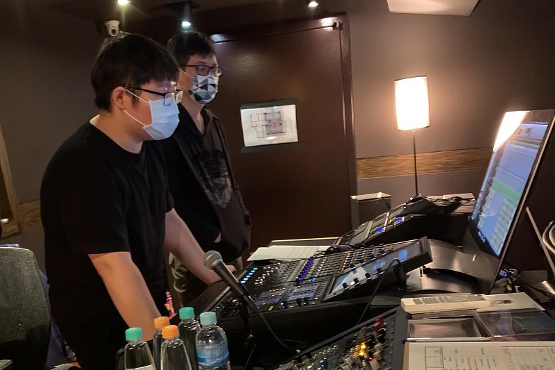 山狗大後生樂團編曲家劉道文指導世新廣電所學生林汶洋（前者）錄音技術。（世新大學提供）