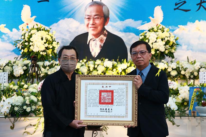 文化部常務次長李連權（右）代表頒贈總統褒揚令，由陳運棟長子陳晟康（左）代表受贈。