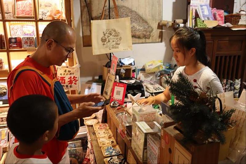 參與集章活動於五條港行號回答該店瑰寶闖關的情景