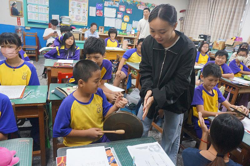 大葉大學運健系二年級的周子安(站立者)幫助同學熟悉高甲戲曲樂器。