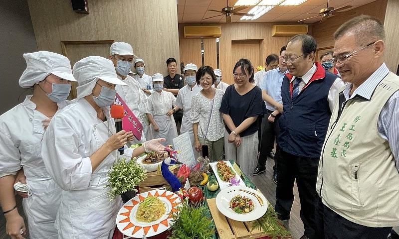 學員不但學習銀髮料理廚藝，還以說菜方式向台南市府勞工局局長王鑫基（右一）、中華醫大孫逸民校長（右二）等貴賓及師長介紹各道料理特色