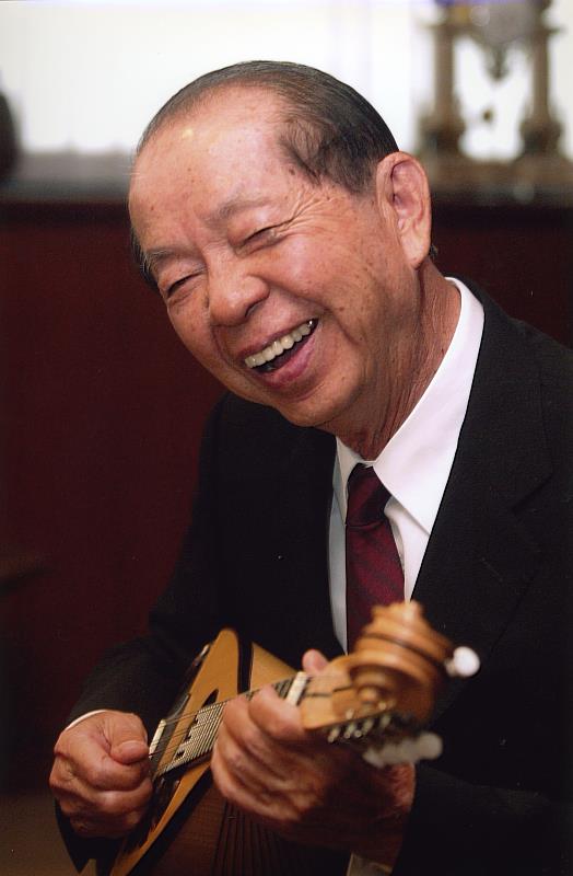 許文龍先生一生致力為臺灣實現幸福感，照片為其閒暇愛好「彈奏曼陀林」。（奇美實業提供）