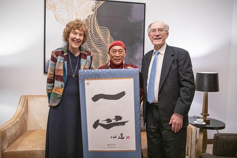 Master Hsin Tao presents his calligraphy work as a gift to two long-time friends, religious scholars Mary Everly Tucker and John Grim, expressing joy in their reunion.