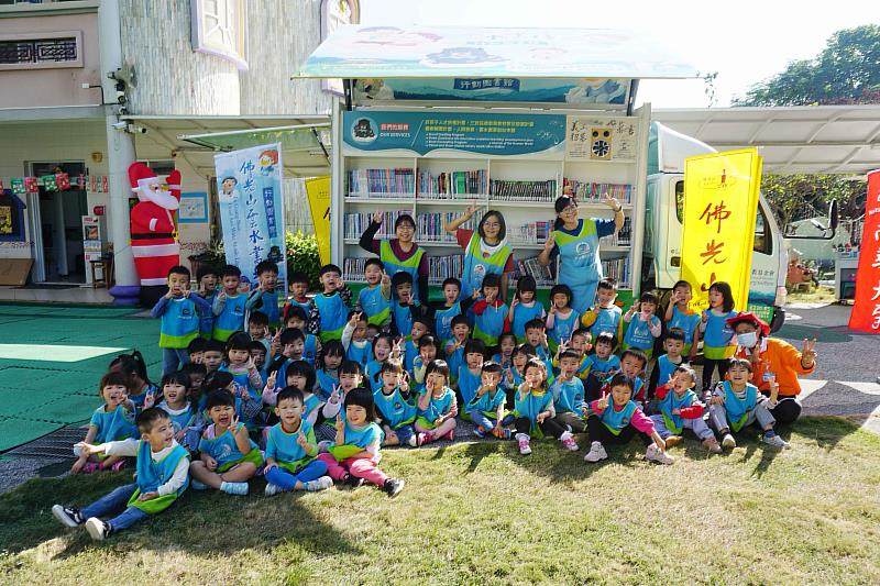 南華大學雲水書車進駐民雄鄉麥米羅幼兒園，推廣兒童閱讀，師生與雲水書車一同合影。