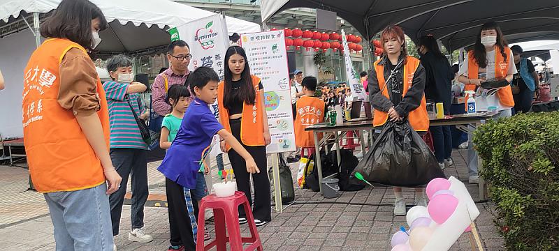 義守大學營養系學生，透過射氣球、丟沙包、卡牌等遊戲，讓民眾可以輕鬆的從遊戲中吸收新知，瞭解健康的飲食觀念(照片來源：義守大學提供)。