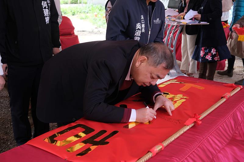 官網-副縣長陳見賢在上樑大吉的紅布條上簽名祝福