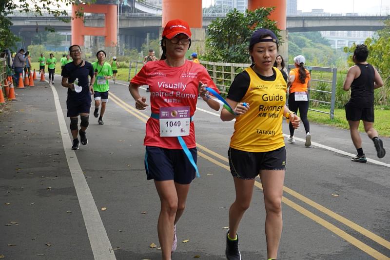 視障跑者張雅惠(左)與中華視障路跑協會陪跑員蔡宇淳（右）報名12公里順利完賽，展現出永不放棄的精神。