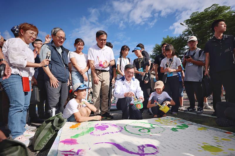 行政院長卓榮泰（前排中）出席「大FUN凱道－兒童未來市」活動，與現場小朋友們一同完成水彩塗鴉作品。