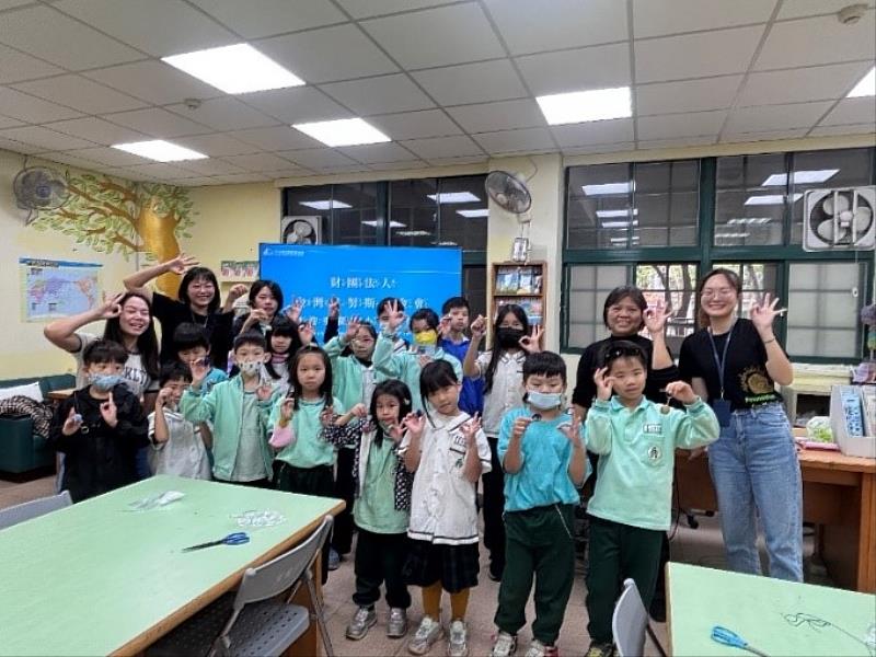 Students from Chongqing Elementary School pose for a group photo after participating in the 