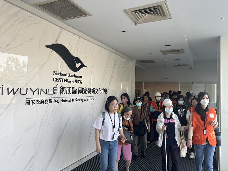 視障朋友聽著導覽老師詳細的介紹，認識到衛武營的建築歷史還有整體形狀