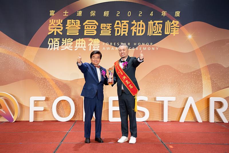富士達保經廖學茂董事長(左)於年度榮譽會活動時，頒發獎項給洪昆憲業務副總(右)。