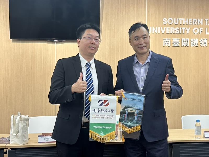 南臺科技大學黃能富校長(右)與國立白河高級商工職業學校林碩彥校長(左)互換錦旗。