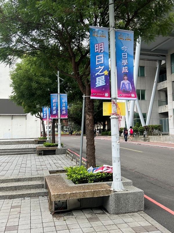 「今日學成 明日之星」閃耀南臺校園，畢業生潛力無限，蓄勢待發。 這面旗幟清晰傳達了學校對畢業生的信心與期許。每一位從南臺畢業的學子，都已具備成為未來行業中堅的力量。旗幟如明燈般指引，鼓勵他們將所學化為光芒，在各自的領域中綻放璀璨，成為真正的明日之星。