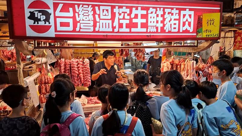 攤商講解豬肉的各部位以及冷鏈運送的衛生觀念。