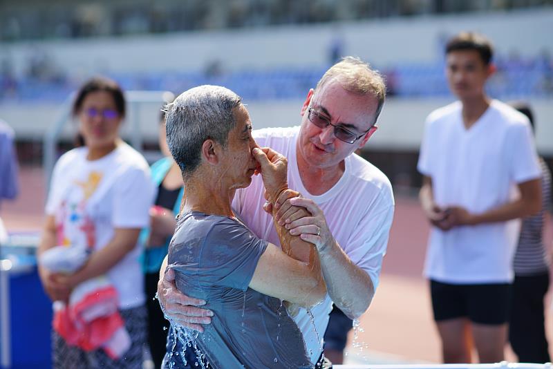 A baptism takes place at an annual convention of Jehovah’s Witnesses. (Photo Courtesy of Jehovah’s Witnesses.)