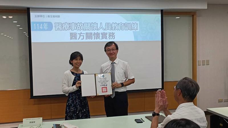 承辦單位財團法人藥害救濟基金會執行長陳文雯(左)頒發衛福部感謝狀給李毅醫師。