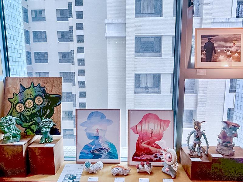 怪趣生動的陶偶昂然佇立，搭配數件迷你雕塑與畫作作品，一同構築出既詼諧又帶點陌生感的異想場景。風格鮮明，令人駐足凝視，彷彿進入另一個充滿個性的小宇宙。